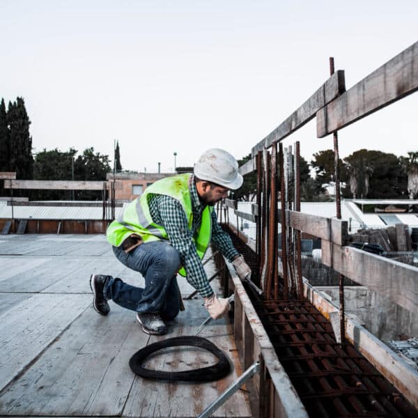 a-formwork-worker-uses-his-tools-to-adjust-ironwor