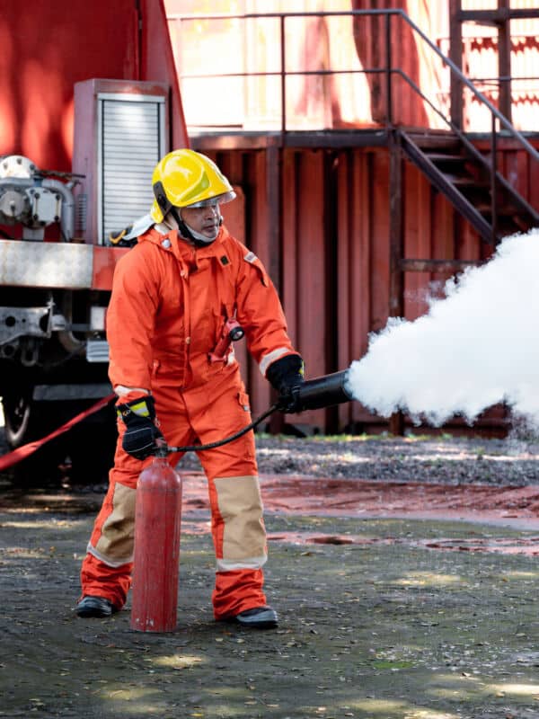 fireman-wearing-firefighting-suite-using-fire